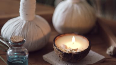 Kräuterstempel, Kerze und ayurvedisches Öl
