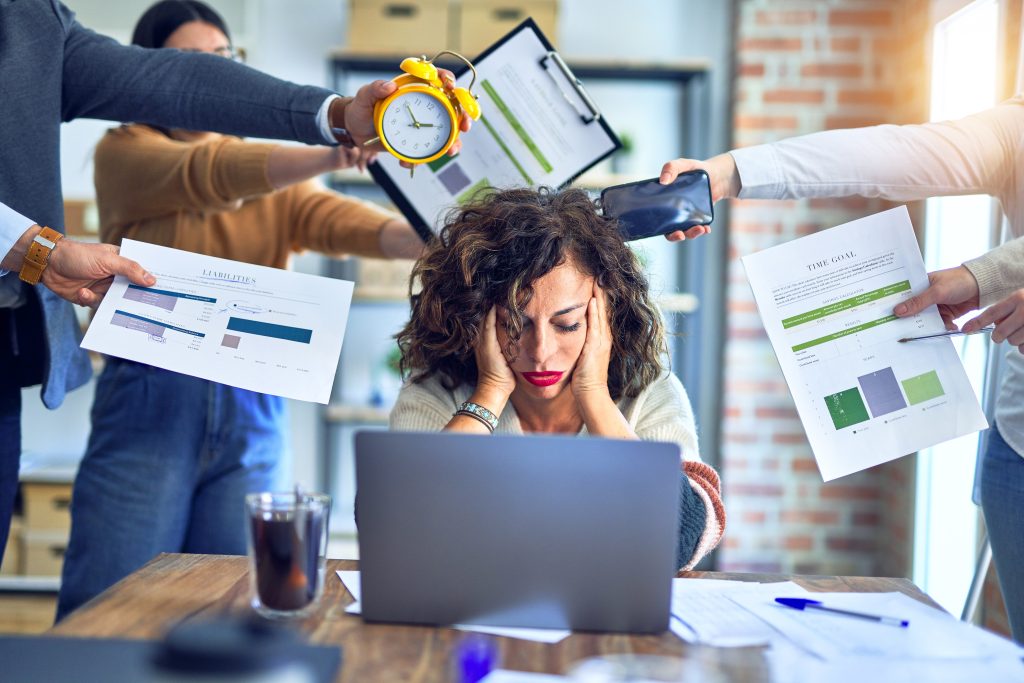 Die Frau schaut vor lauter Stress verzweifelt auf Ihren Laptop