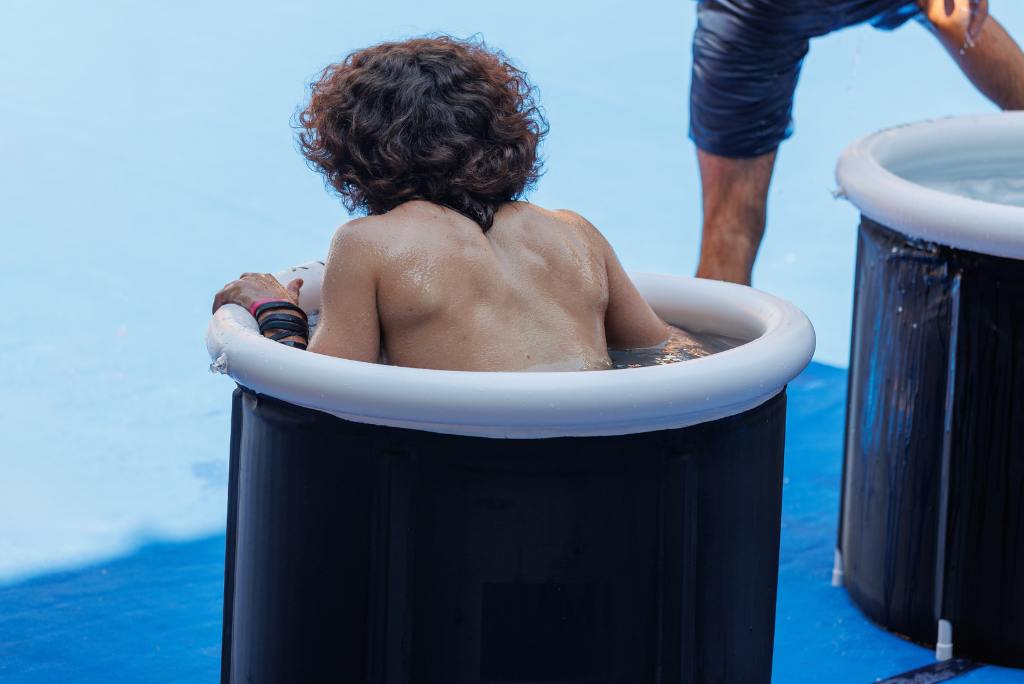 Eine Frau badet in einer Eistonne