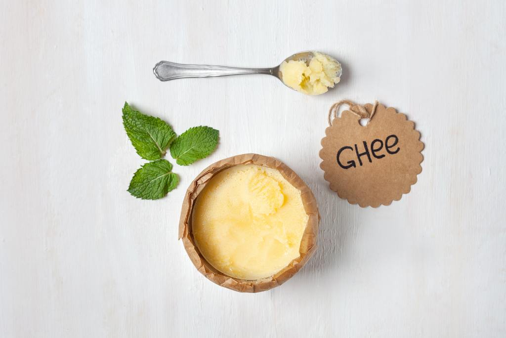 Eine Schale mit Butterschmalz, daneben ein Schild mit der Aufschrift "Ghee"
